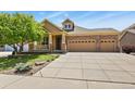 Charming two-story home with manicured lawn and spacious three car garage at 23426 Briar Leaf Ave, Parker, CO 80138