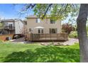 Spacious backyard with lush green grass, landscaping and a wooden deck perfect for relaxation at 408 Sylvestor Trl, Highlands Ranch, CO 80129