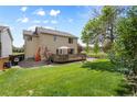 Enjoy outdoor living on this home's wooden deck and spacious backyard, perfect for entertaining at 408 Sylvestor Trl, Highlands Ranch, CO 80129