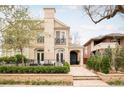 Elegant two-story home featuring a landscaped yard, stone facade, black wrought iron accents, and a well-manicured front garden at 350 Adams St, Denver, CO 80206