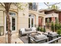 Outdoor patio with a fire pit, comfortable seating, and access to the main house through elegant glass doors at 350 Adams St, Denver, CO 80206