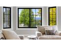 Comfortable living room featuring a large window with green backyard views and plush seating at 1311 Fletcher Dr, Erie, CO 80516