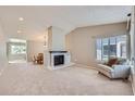 Inviting living room features a fireplace, neutral decor, and lots of natural light at 31 Shetland Ct, Highlands Ranch, CO 80130