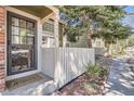 Inviting front porch with address display, leading to the main entrance with secure screen door at 14076 E Radcliff Cir, Aurora, CO 80015