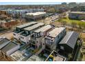 Aerial view of new townhomes and surrounding cityscape with rooftops and mature trees at 2451 Lawrence St # 2, Denver, CO 80205