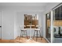 Bright breakfast nook with seating for two and a view of the outdoors at 2451 Lawrence St # 2, Denver, CO 80205