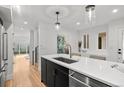 Bright, modern kitchen with stainless steel appliances, sleek island, and hardwood flooring at 2451 Lawrence St # 2, Denver, CO 80205