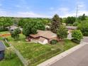 Aerial view of a home showing the fenced backyard, mature trees and proximity to surrounding neighborhood at 8198 E Lehigh Dr, Denver, CO 80237