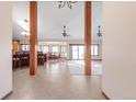 Open-concept living area with wooden beams, tile flooring, and a view of the dining area at 103 Red Wing Ct, Mead, CO 80542