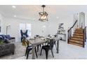 Beautiful dining room with stylish furniture, marble floors, and modern light fixtures at 1104 S Biscay St, Aurora, CO 80017