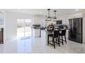 Stylish kitchen with modern appliances, center island with seating, and ample counter space at 1104 S Biscay St, Aurora, CO 80017