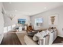 Inviting living room featuring a large window and entertainment center at 4548 River Highlands Loop, Elizabeth, CO 80107