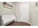 Inviting entryway with coat rack, bench, and white door at 21028 E Saratoga Ave, Aurora, CO 80015