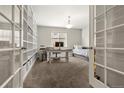Bright office features a built-in bookshelf, a desk and a comfortable daybed for relaxing or accommodating guests at 21028 E Saratoga Ave, Aurora, CO 80015