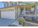 Inviting front porch with stone accents and well manicured landscaping at 4708 Rock Pipit Ct, Highlands Ranch, CO 80126