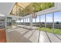 Sunlit dining space featuring floor-to-ceiling windows, a sleek table, and stylish chandeliers at 5700 S Quebec St # A, Englewood, CO 80111