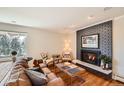 Cozy living room featuring a fireplace, hardwood floors, and comfortable seating at 6671 S Hill Way, Littleton, CO 80120