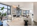 Bright living room with modern fireplace, sleek lighting fixture, floor to ceiling windows and city views at 1901 Wazee St # 1020, Denver, CO 80202