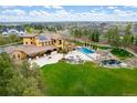 Aerial view of the back of home featuring a pool, hot tub, pergola, fire pit, and backyard at 8417 High Ridge Ct, Castle Pines, CO 80108
