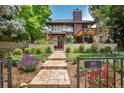 Charming home exterior with professionally landscaped front yard and inviting stone walkway leading to the front door at 460 Garfield St, Denver, CO 80206