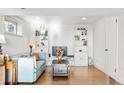 Cozy finished basement featuring wood floors, white shelving, and a comfortable couch at 13225 W Jewell Cir, Lakewood, CO 80228