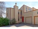 Modern townhome with a red front door and attached one car garage in a landscaped neighborhood at 8917 E Chenango Ave, Greenwood Village, CO 80111