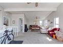 Inviting living room featuring vaulted ceilings, bright windows, and comfortable seating arrangement at 8917 E Chenango Ave, Greenwood Village, CO 80111