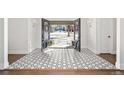 Elegant entryway featuring striking tile flooring, decorative wreaths, and double doors at 39 Sedgwick Dr, Cherry Hills Village, CO 80113