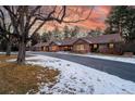 Beautiful brick home with large front yard, mature trees, and long driveway at 39 Sedgwick Dr, Cherry Hills Village, CO 80113