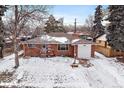Inviting single-story brick house with attached garage and snow-covered front yard at 205 Coral Way, Broomfield, CO 80020