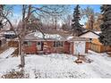 Cozy brick home featuring an attached garage and snow-covered front yard at 205 Coral Way, Broomfield, CO 80020