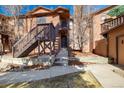 Charming two-story condo with private entrance and wooden stairs leading to the front door at 9587 W 89Th Cir, Broomfield, CO 80021