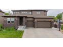 Charming two-story home with brick accents, a two-car garage, and a well-maintained lawn at 11880 W 38Th Pl, Wheat Ridge, CO 80033