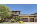 Charming two-story home with three-car garage and beautiful landscaping, featuring a cozy front porch at 9470 S Silent Hills Dr, Lone Tree, CO 80124