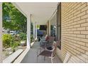 Inviting front porch with seating area and lush landscaping, great for outdoor relaxation at 11035 W 26Th Pl, Lakewood, CO 80215