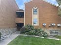 Exterior shot of a brown two story condo with stone accents and well maintained landscaping at 4281 S Salida Way # 5, Aurora, CO 80013