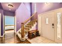 Bright entryway with staircase, tiled floor, and view into the bedroom at 9306 W 13Th Pl, Lakewood, CO 80215