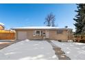 Brick Ranch home with attached garage, snowy yard at 4070 W Dartmouth Ave, Denver, CO 80236