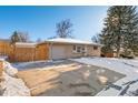 Front view of Ranch home with attached garage and driveway at 4070 W Dartmouth Ave, Denver, CO 80236