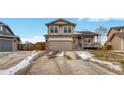 Charming two-story home featuring a covered front porch, attached two-car garage, and well-maintained landscaping at 5819 W 82Nd Cir, Arvada, CO 80003