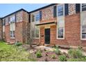 Traditional brick home boasts colorful landscaping and charming black shutters at 1165 Krameria St, Denver, CO 80220