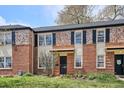 Traditional brick home boasts colorful landscaping and black shutters at 1165 Krameria St, Denver, CO 80220