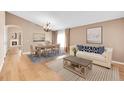 Bright living room with neutral walls, a dining area with a chandelier, and a comfortable sofa at 5162 Hubert St, Parker, CO 80134