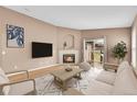 Cozy living room with a fireplace, TV, and sliding glass door leading to the backyard at 5162 Hubert St, Parker, CO 80134