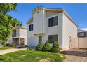 Two-story home featuring a well-maintained lawn and a one-car garage on a sunny day at 4520 Andes St, Denver, CO 80249
