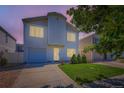 Two-story home featuring a well-maintained lawn and a one-car garage at dusk at 4520 Andes St, Denver, CO 80249