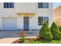 Well-maintained house featuring a lush lawn and blooming flower garden at 4520 Andes St, Denver, CO 80249