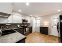 Well-lit kitchen features updated appliances, countertops, and tile floors at 8231 S Fillmore Way, Centennial, CO 80122