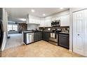 Modern kitchen features stainless steel appliances and granite countertops at 8231 S Fillmore Way, Centennial, CO 80122
