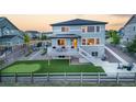 A backyard with golf putting green, large patio, and deck at 16701 Buffalo Run Dr, Commerce City, CO 80022